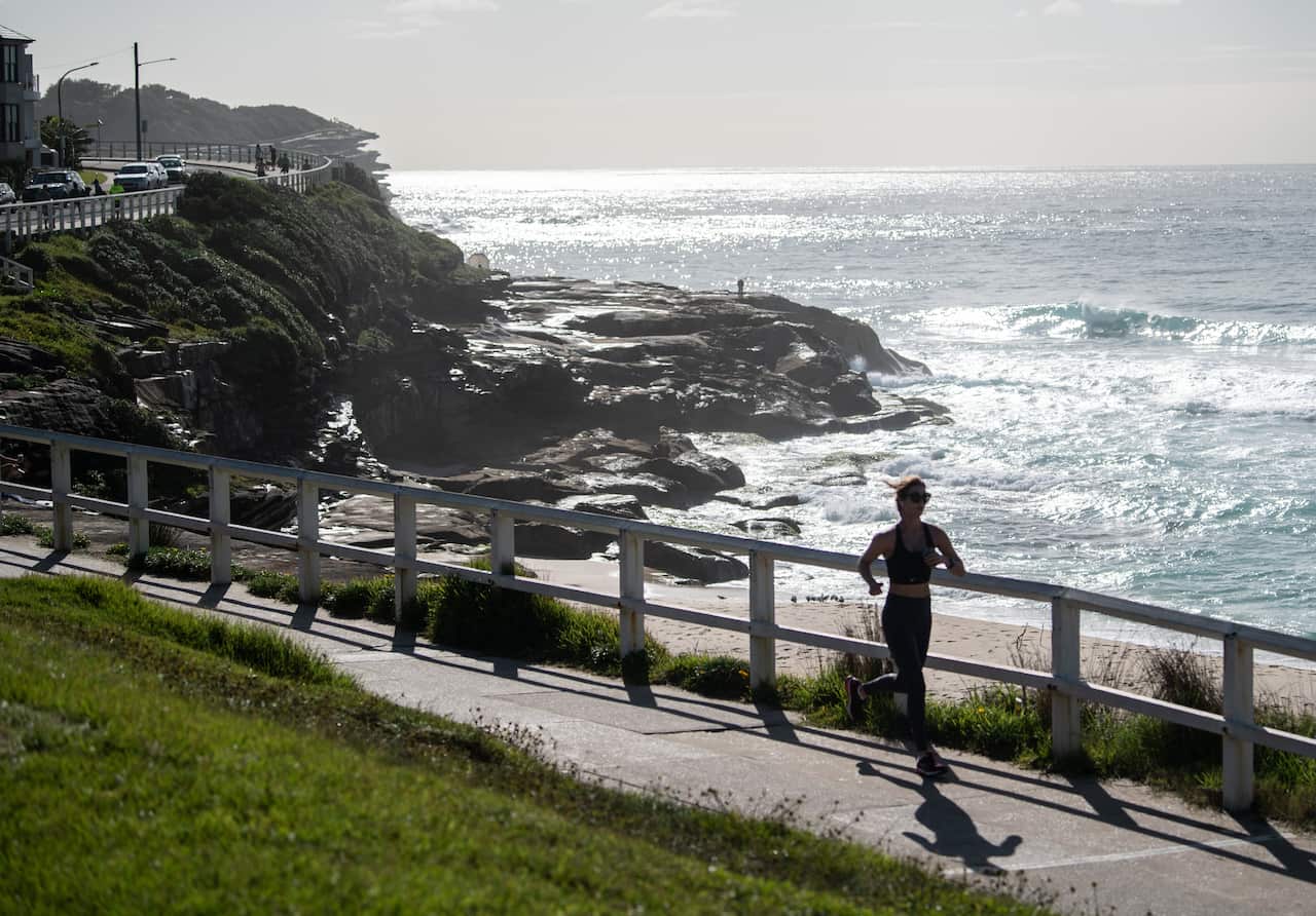 Woman running near an empty Bronte Beach