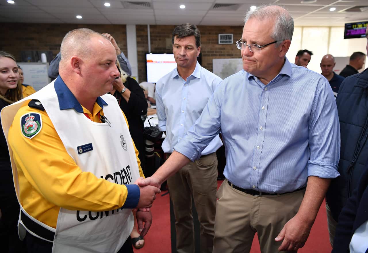 Prime Minister Scott Morrison and NSW Premier Gladys Berejiklian are briefed during a visit to the Wollondilly Emergency Control Centre in Sydney.