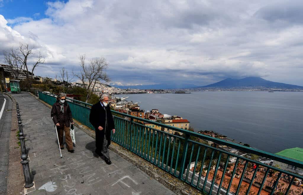 People wearing protective masks walk in the street