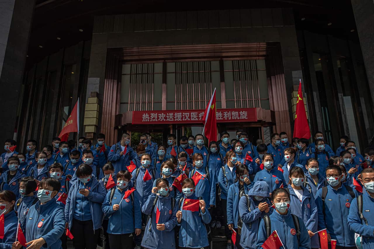 Chinese medical workers from Shandong province take part in a ceremony before leaving Wuhan.