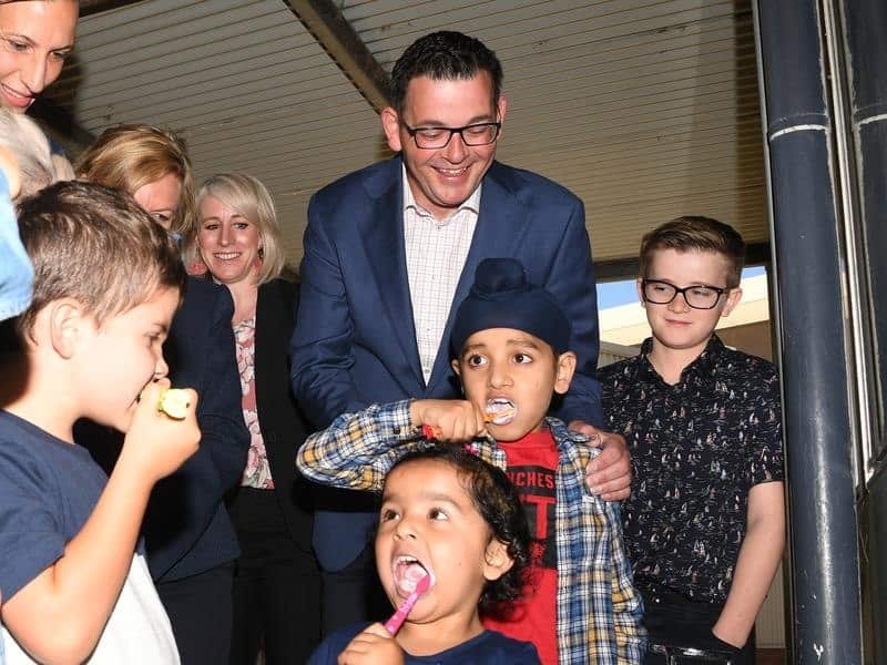 Victorian Premier Daniel Andrews with kids brushing their teeth