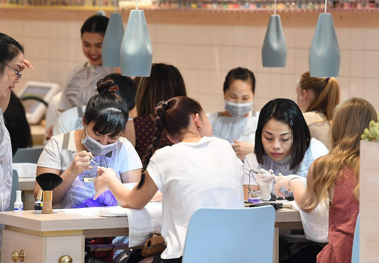 Customers receive manicures at a nail salon in Townsville, Friday, Nov. 10, 2017. (AAP Image/Dave Hunt) NO ARCHIVING