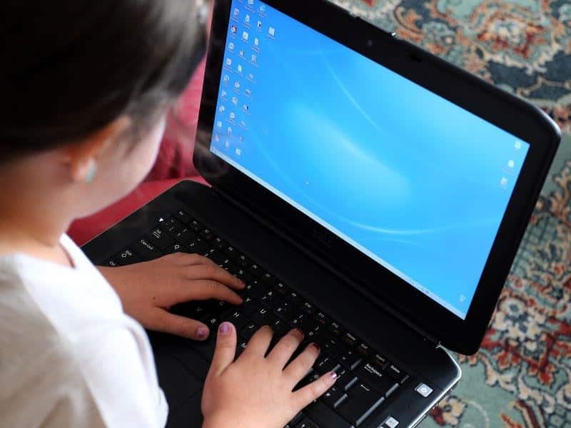 A stock image of a child using a laptop