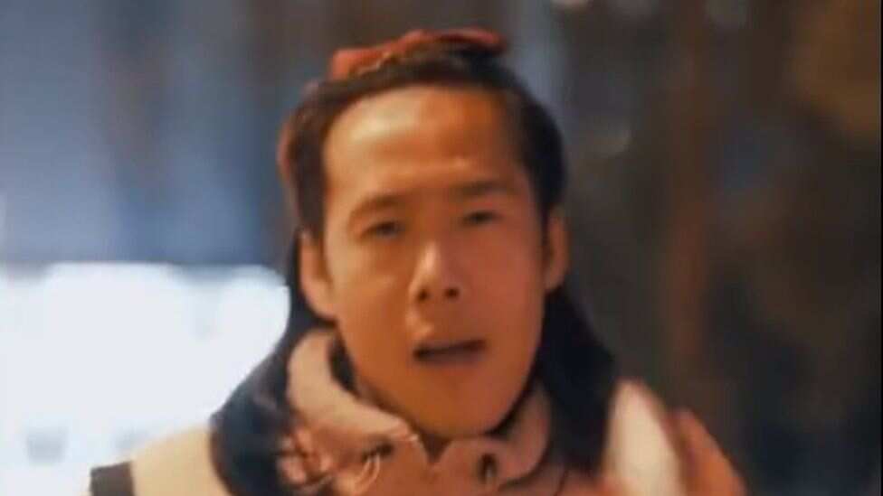 In the ad, the woman wipes away her makeup to reveal a man's face.