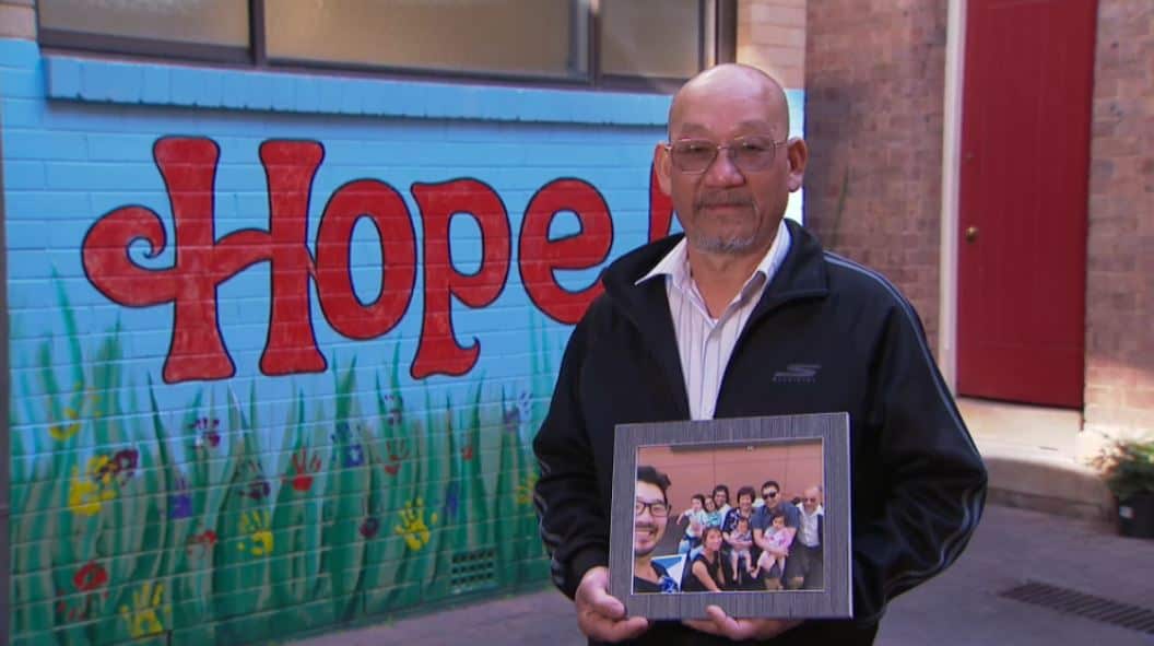 Sunny Chan with a portrait of his family.