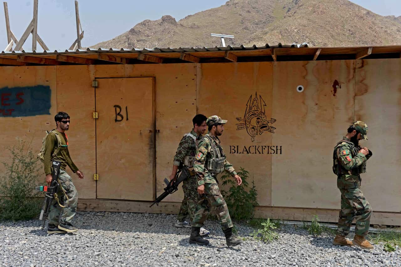 In this 2020 photo, Afghan National Army (ANA) soldiers walk in a US military base which had recently handed over to Afghan forces in Nangarhar province.