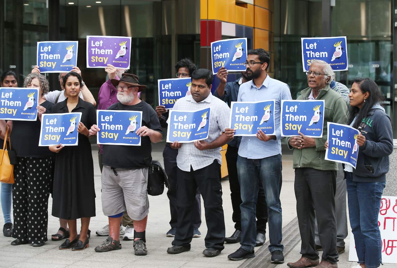 A group of supporters for the family in front of the Federal Court of Australia in Melbourne during the hearings in February. 