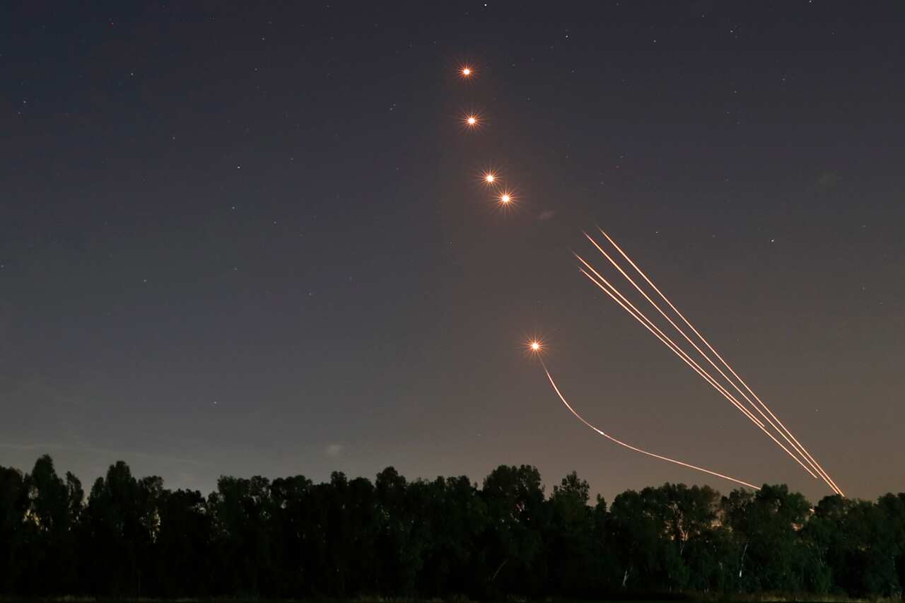 The trail of a rocket fired by the Israeli anti-rocket defence system intercepts rockets fired from Gaza Strip, near the city of Sderot, Israel, 13 May 2021.