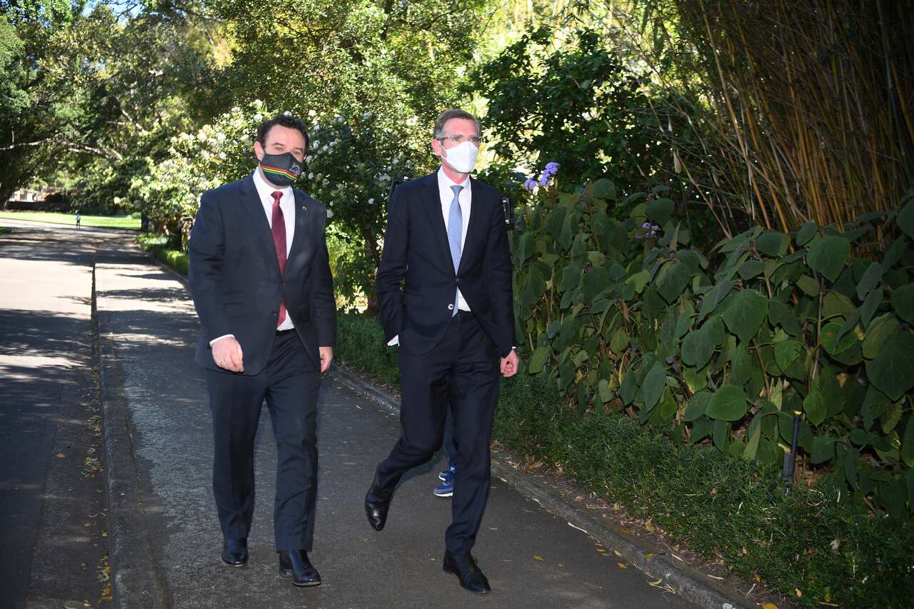 Newly elected Premier Dominic Perrottet (right) arrives with Deputy Leader Stuart Ayres (left) for a swearing in ceremony at NSW Government 
