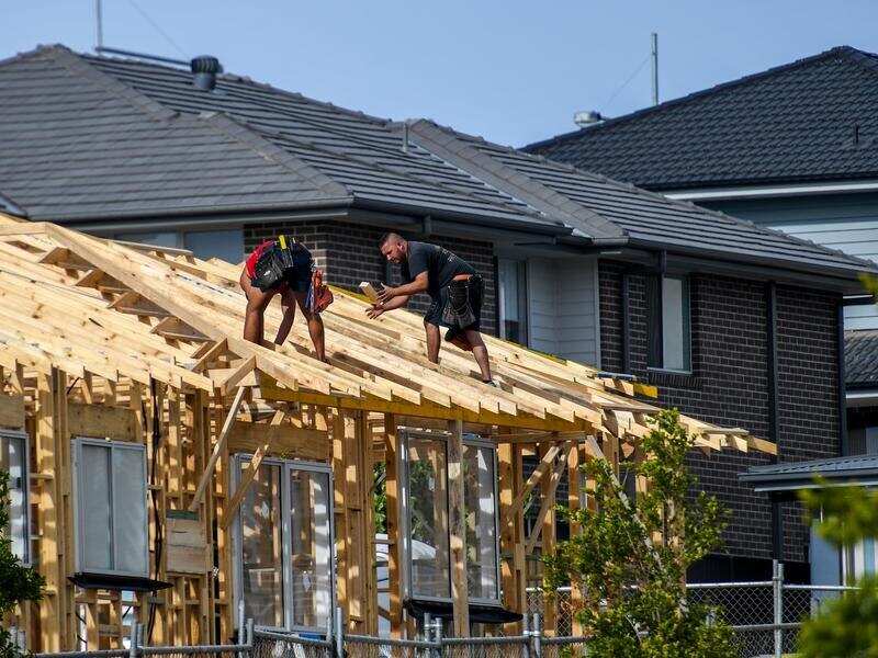 Construction workers build a house in Sydney's southwest