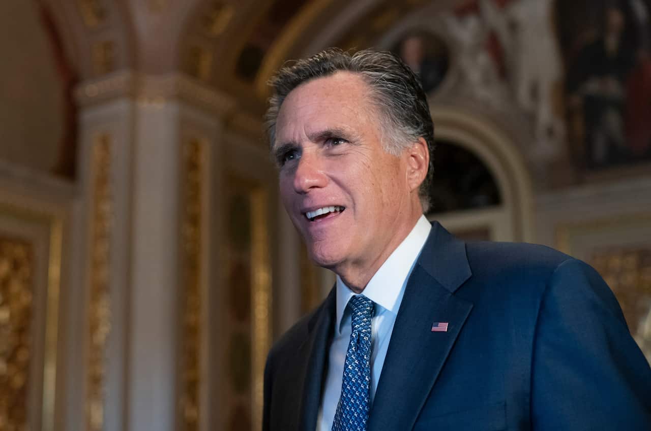 Sen. Mitt Romney, R-Utah, talks to a reporter outside the Senate chamber during a break in President Donald Trump's impeachment trial, at the Capitol in Washington, Wednesday, Jan. 29, 2020.