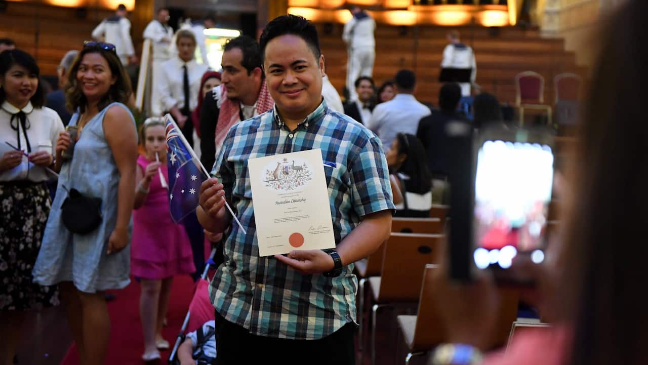 An Australian citizenship recipient poses for a photo after a citizenship ceremony on Australia Day in Brisbane, Thursday, Jan. 26, 2017. (AAP Image/Dan Peled)