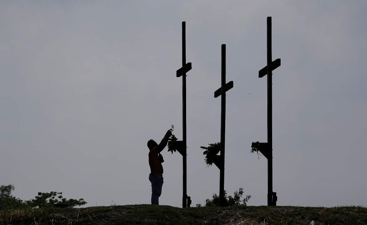 A Filipino penitent places his crown of thorns during Good Friday rituals to atone for sins.
