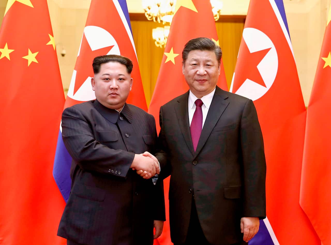 North Korean leader Kim Jong Un, left, and Chinese President Xi Jinping poses for a photo in Beijing.