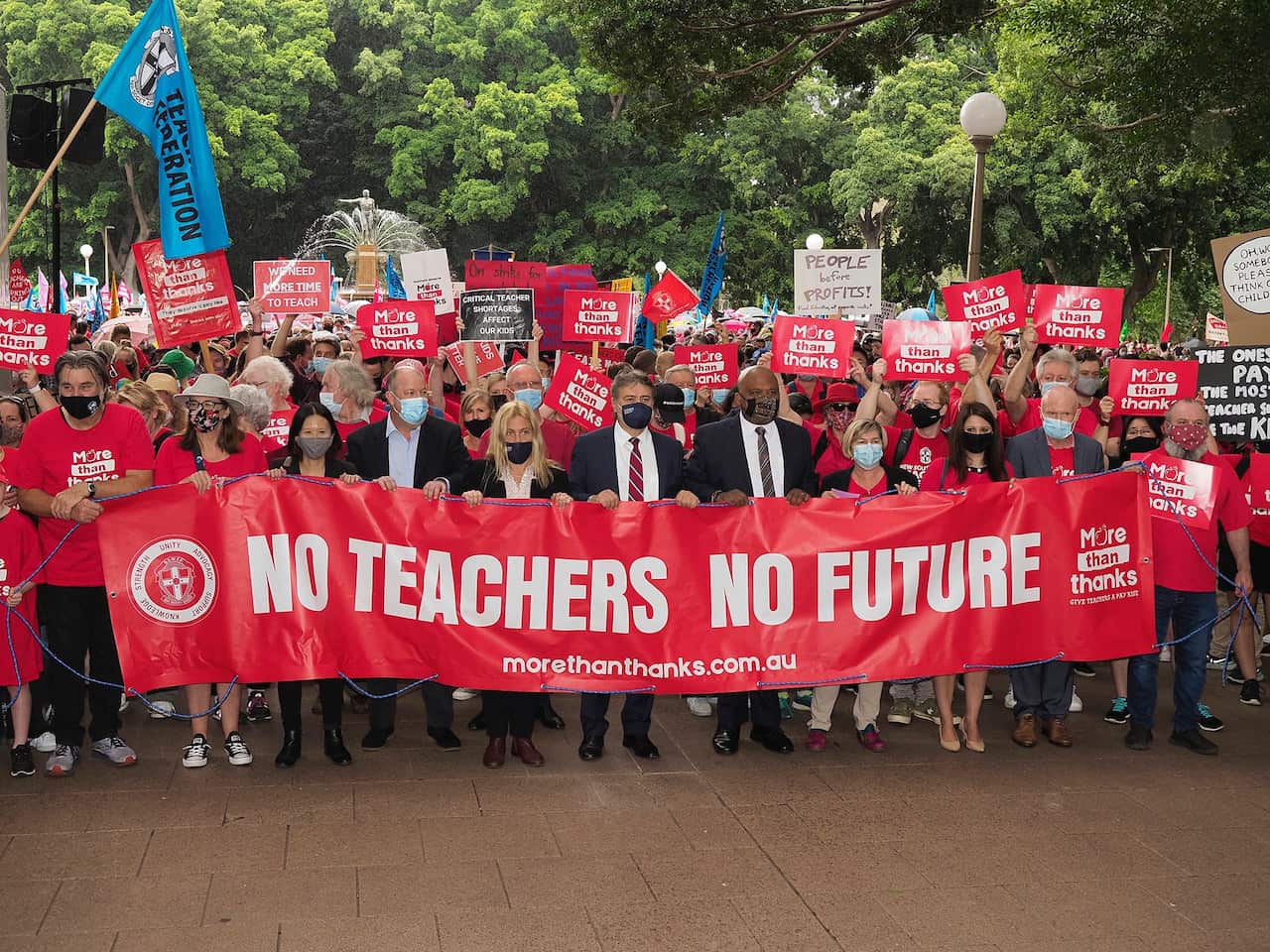 Ms Leung carries a banner that says 'No Teachers No Future' in a strike for teachers' rights IN NSW.