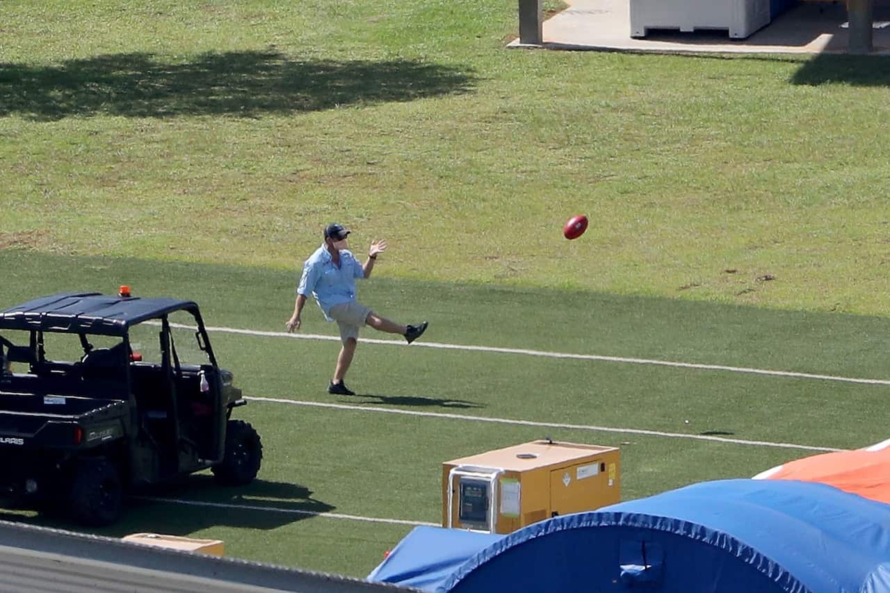 A member of the medical team playing football at the detention center.Credit...