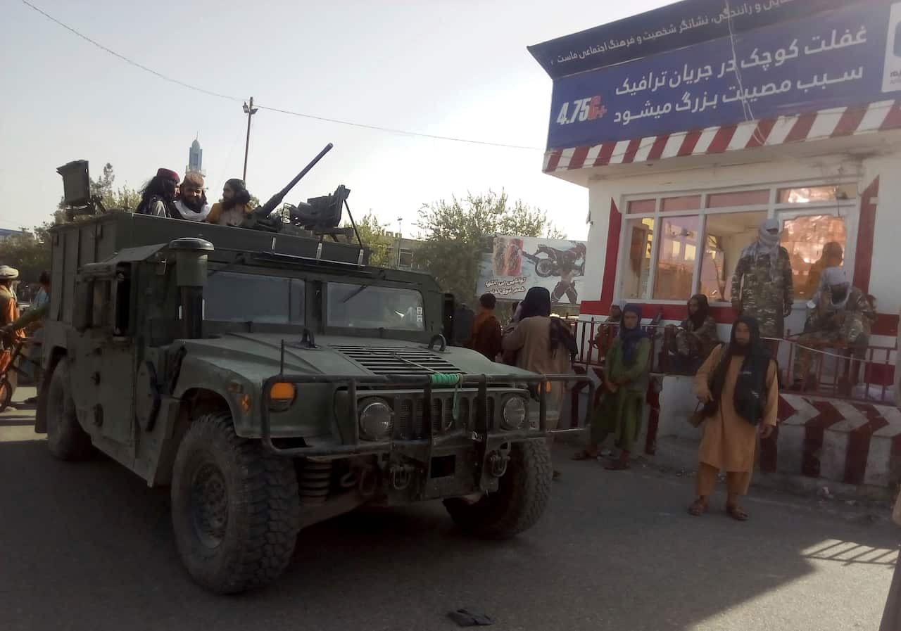 Taliban fighters stand guard at a checkpoint in Kunduz city, northern Afghanistan, on Monday, 9 August, 2021.