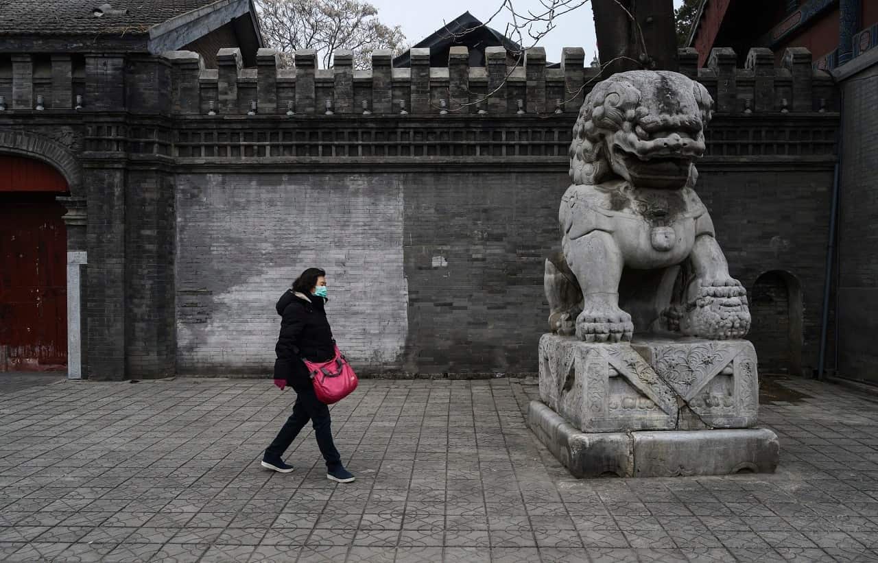 A Chinese woman wears a protective mask in Beijing.