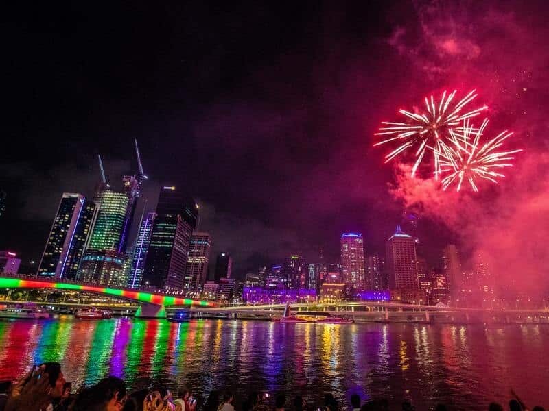People watch fireworks on New Year's Eve over the Brisbane River