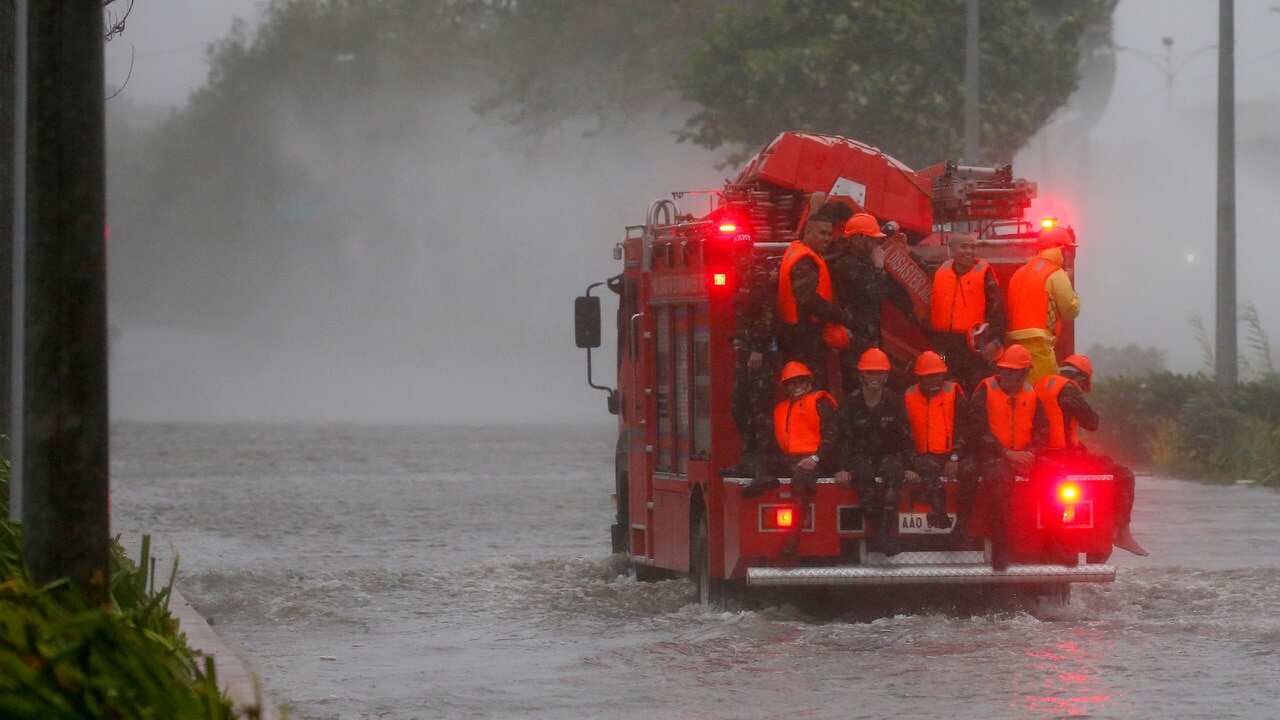 Fire rescuers head to low-lying areas in Manila under heavy rains and strong winds brought about by Typhoon Mangkhut.