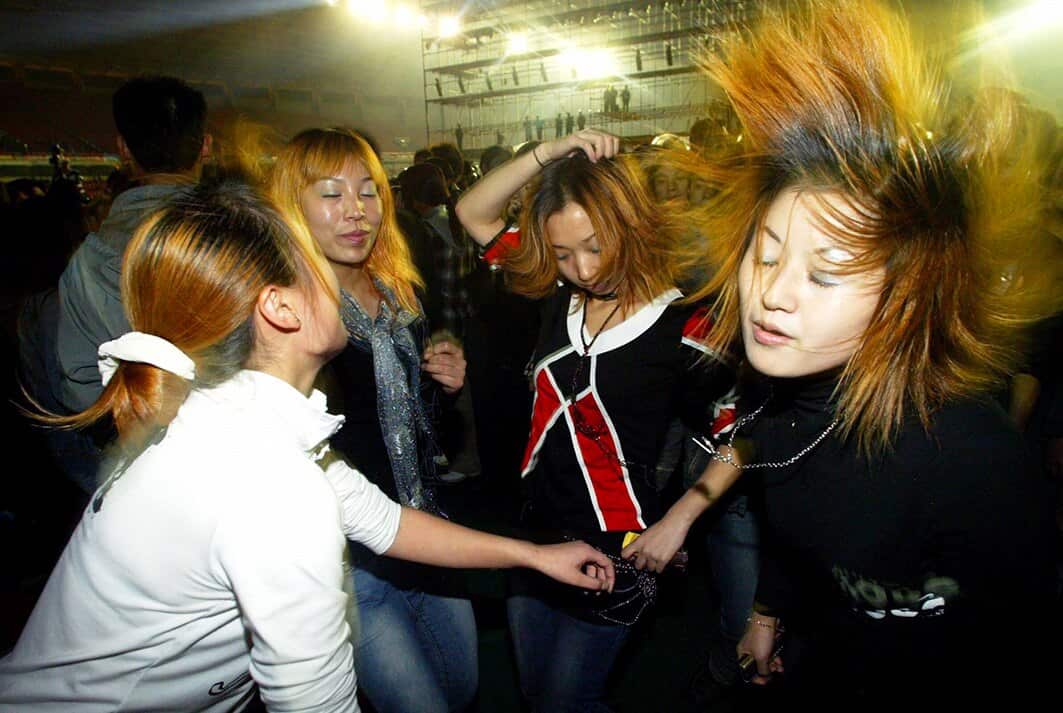 Young people dance during an open rave party