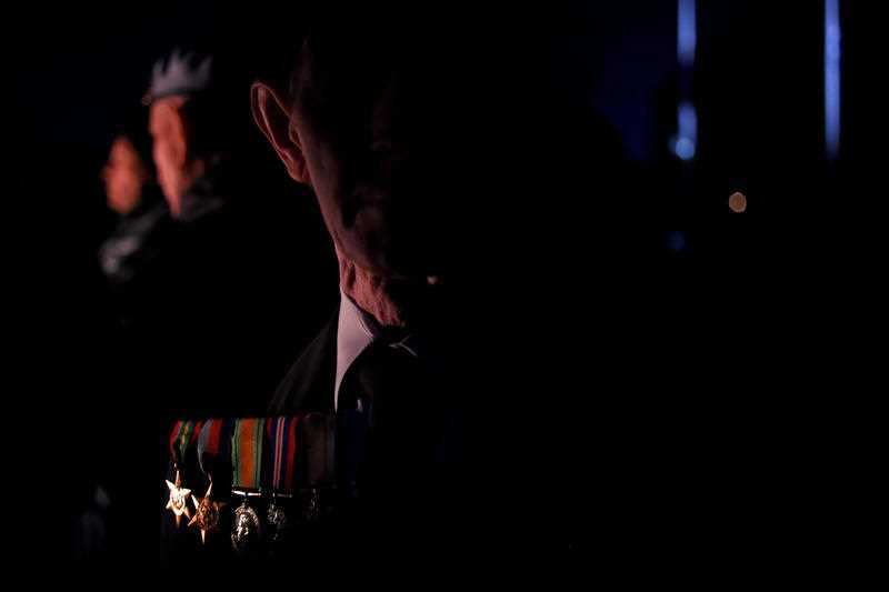 Peter Rodwick of the UK watches the eternal flame at the Shrine of Rememberance for the Anzac Day dawn service in Melbourne
