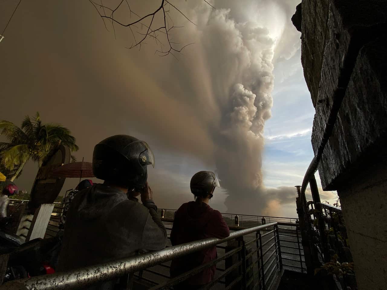 People watch from Tagaytay, Cavite province as Taal Volcano erupts Sunday 12 January 12, 2020. 