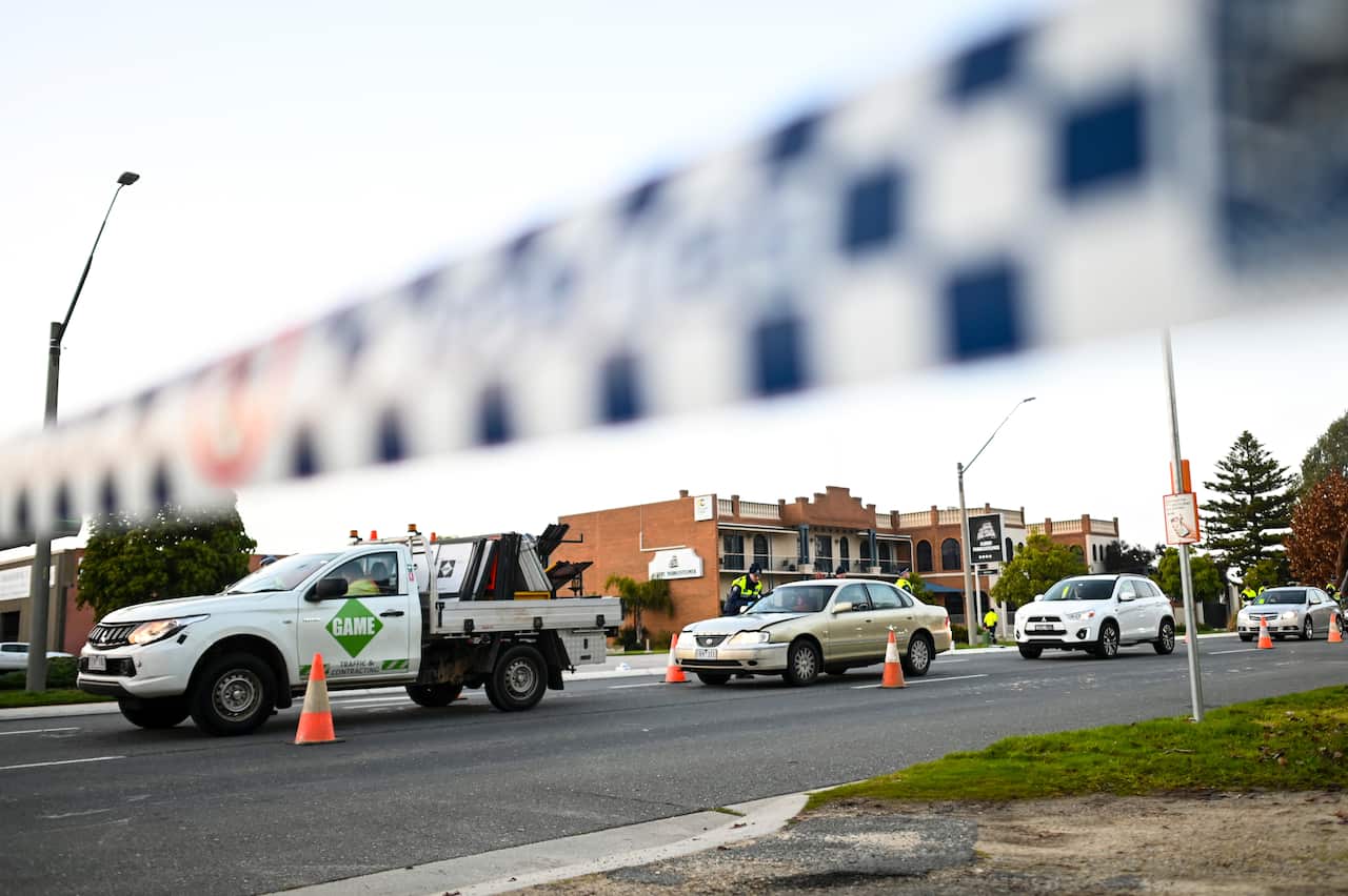 NSW Police officers check cars crossing from Victoria at a border check point in the border town of Albury.