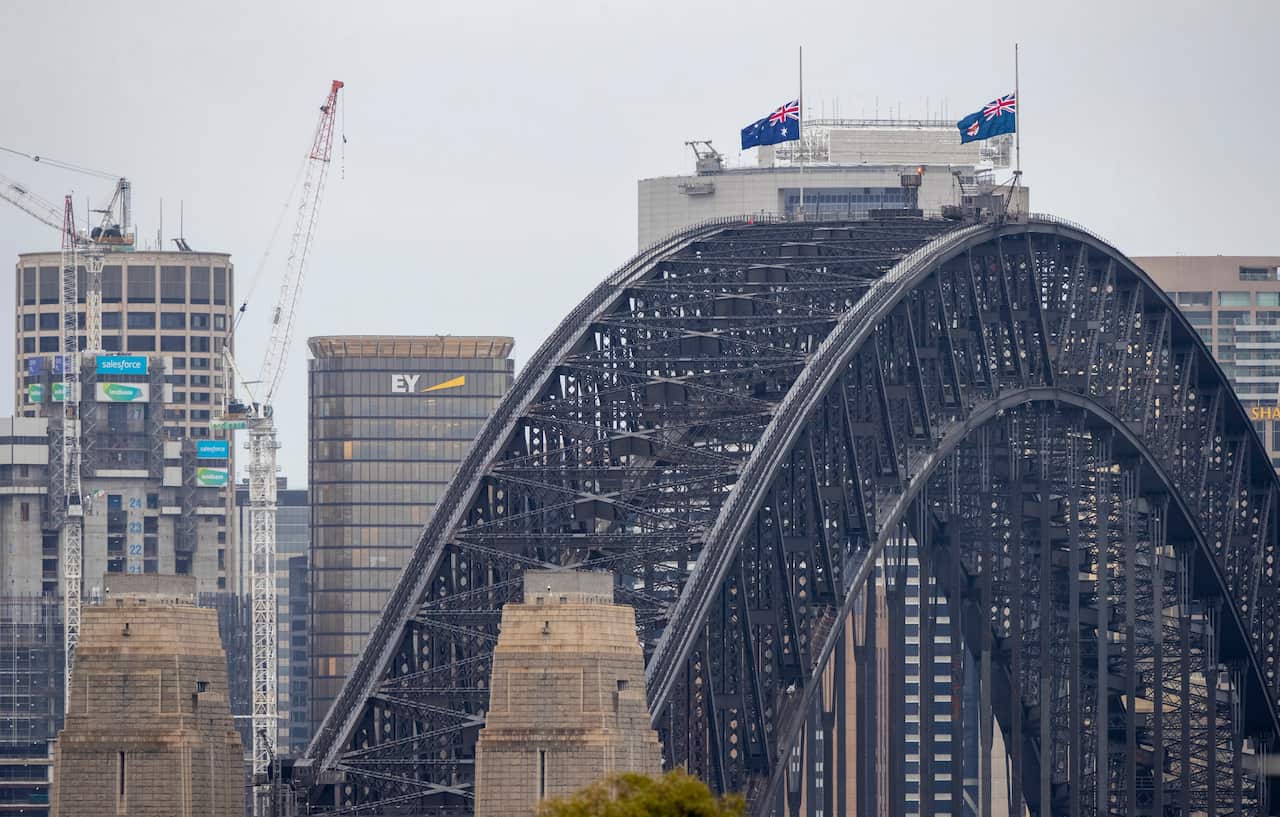 Flags fly at half mast on the Sydney Harbour Bridge as a tribute to the passing of Prince Philip in Sydney, Australia, Saturday, April 10, 2021. Buckingham Palace officials say Prince Philip, the husband of Queen Elizabeth II, has died. He was 99. Philip 