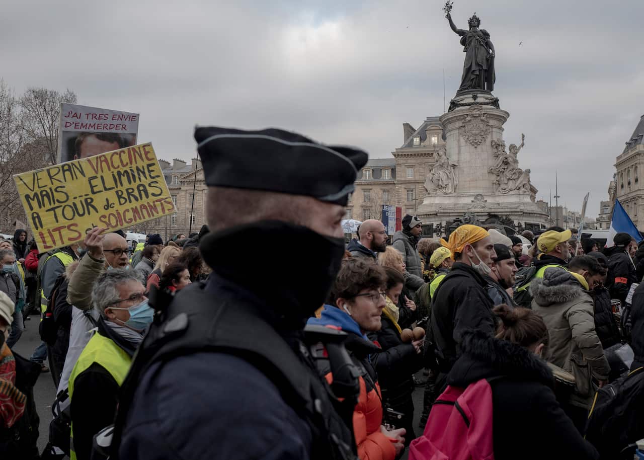 Demonstrators, in opposition to vaccine pass and vaccinations to protect against COVID-19 during a rally in Paris, France, Saturday, Jan. 22, 2022. (AP Photo/Rafael Yaghobzadeh)(AP Photo/Rafael Yaghobzadeh)