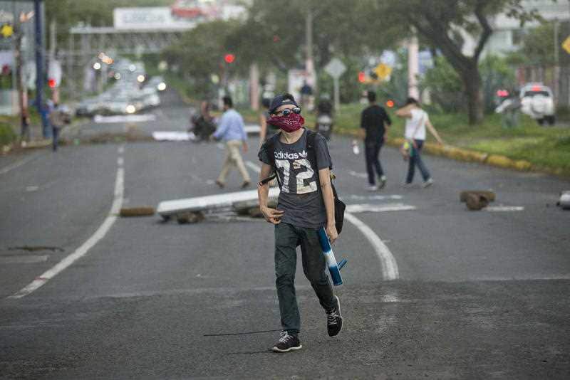 A young man holds a mortar spear during a protest in support of the city of Masaya in Managua, Nicaragua, 04 June 2018.