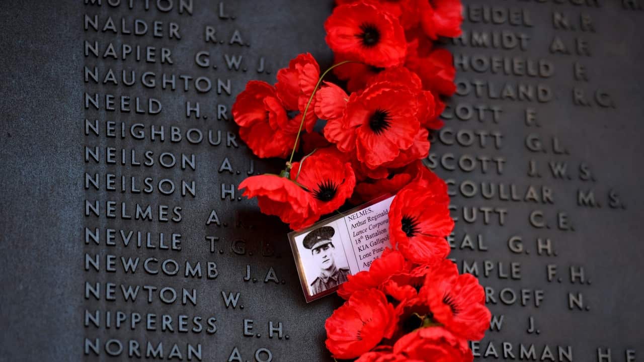 Personal messages are seen amongst the poppies on the Roll of Honour during Remembrance Day at the Australian War Memorial, in Canberra.