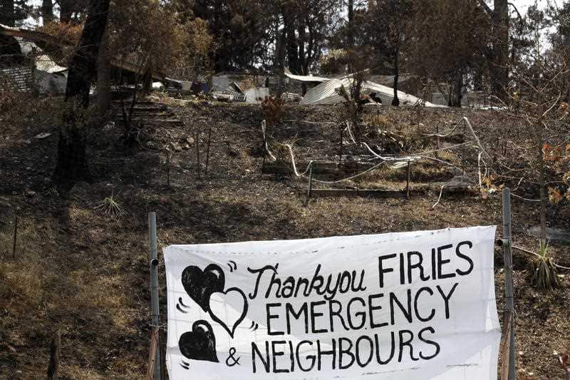 A sign is displayed beside a burned out house near Mogo, Australia, Thursday, 9 Jan, 2020.