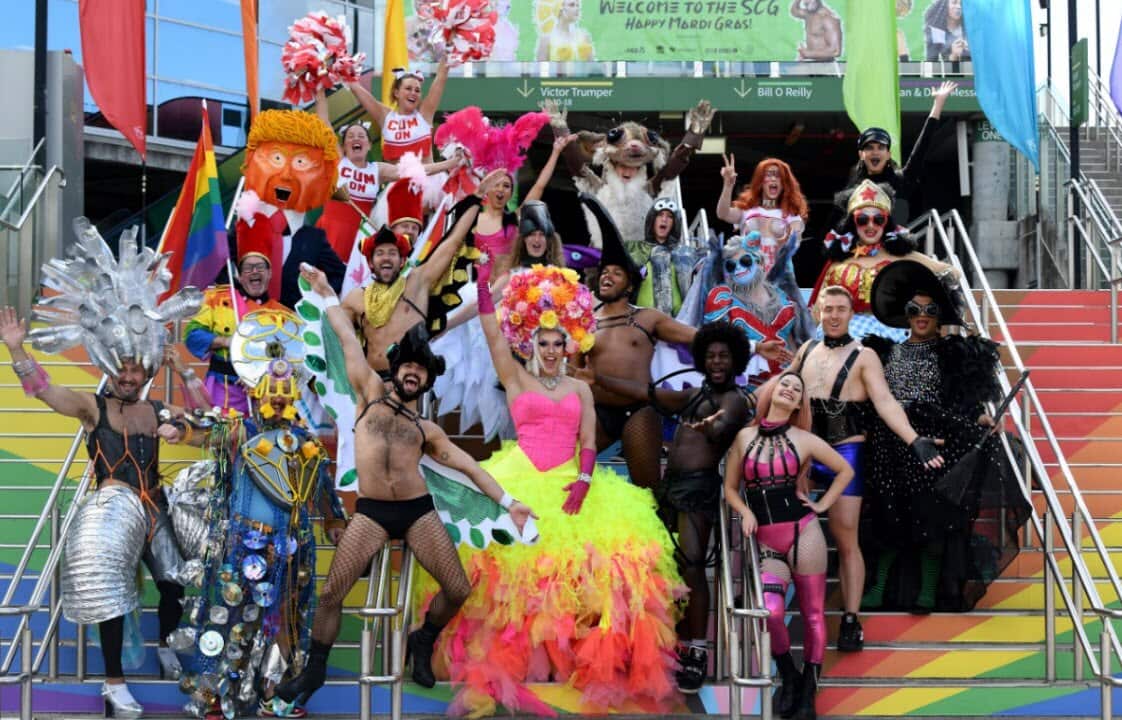 Participants of the parade pose for a photography during a preview of the 2021 Gay and Lesbian Mardi Gras at the SCG,
