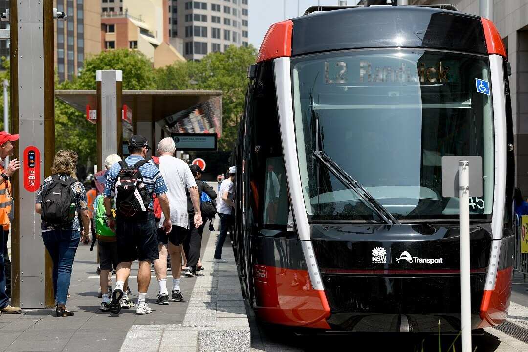 Passengers are seen lining up to ride the new light rail after it was officially opened to the public at Circular Quay in Sydney, Saturday, December 14, 2019. (AAP Image/Bianca De Marchi) NO ARCHIVING