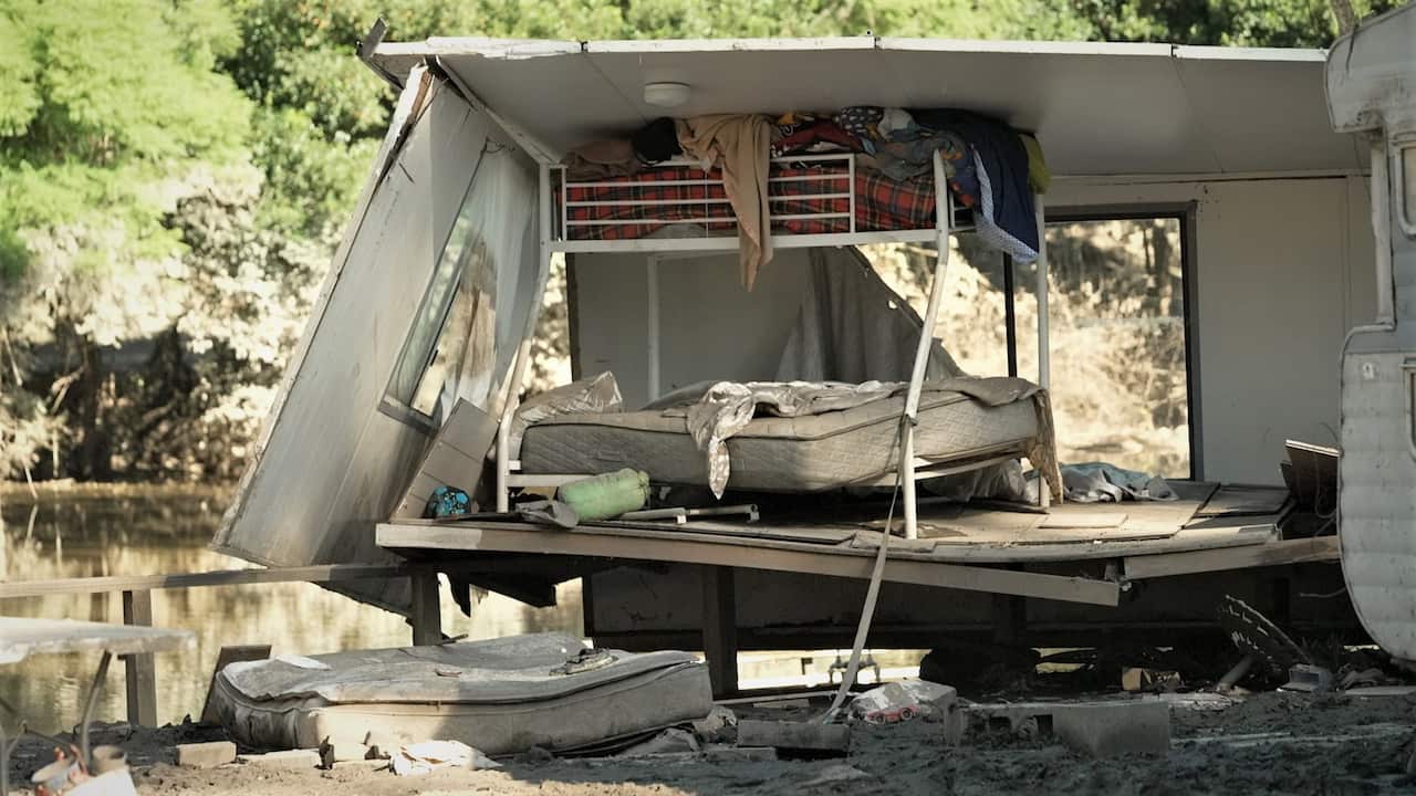 A damaged caravan by the Hawkesbury River.
