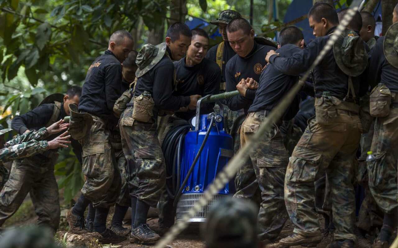 Thai soldiers carry an equipment during rescue operations for 12 boys and their coach trapped in Tham Luang cave.