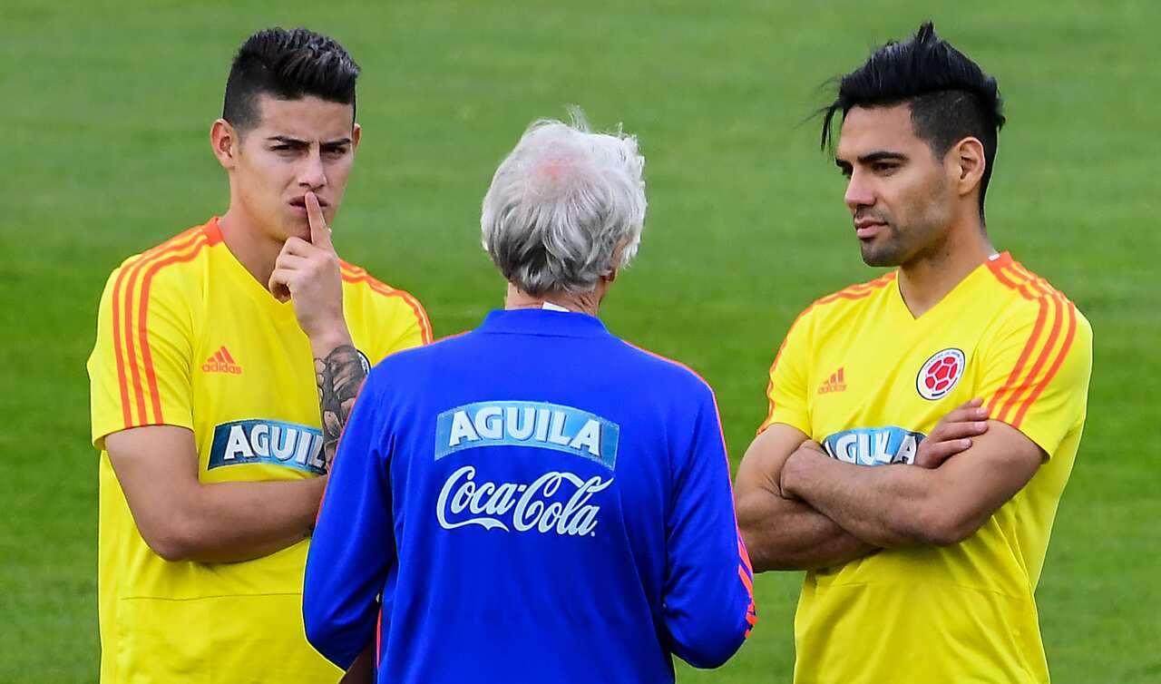 James Rodriguez and Falcao chat with a coach of Colombia