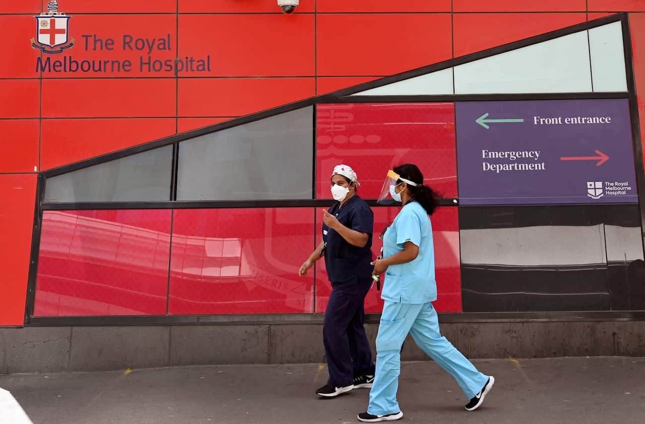 Medical staff walk past the emergency entrance at the Royal Melbourne Hospital in Melbourne.