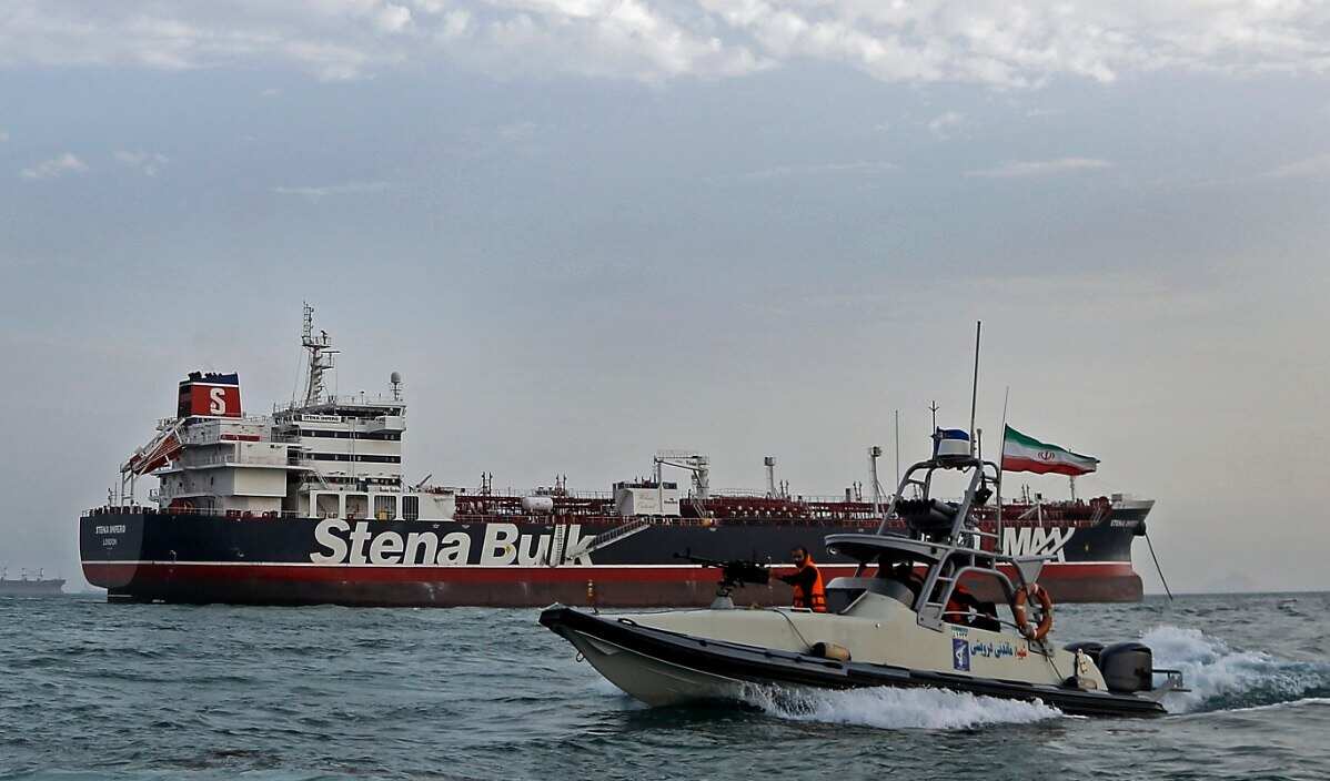 An Iranian Revolutionary Guard jet boat sails around the seized British-flagged tanker Stena Impero in Bandar Abbas, southern Iran, 21 July 2019 