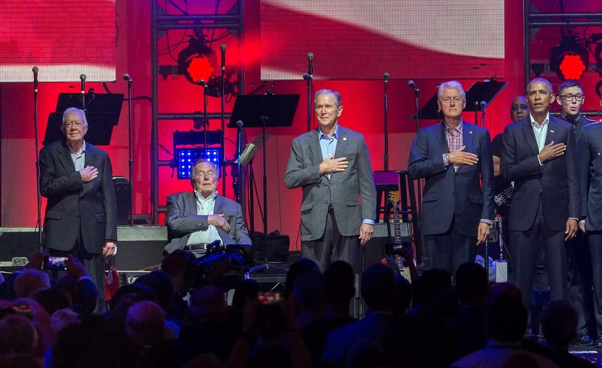 George HW Bush, Bill Clinton and Barack Obama stand for the national anthem at a Hurricane Relief concert in 2017.