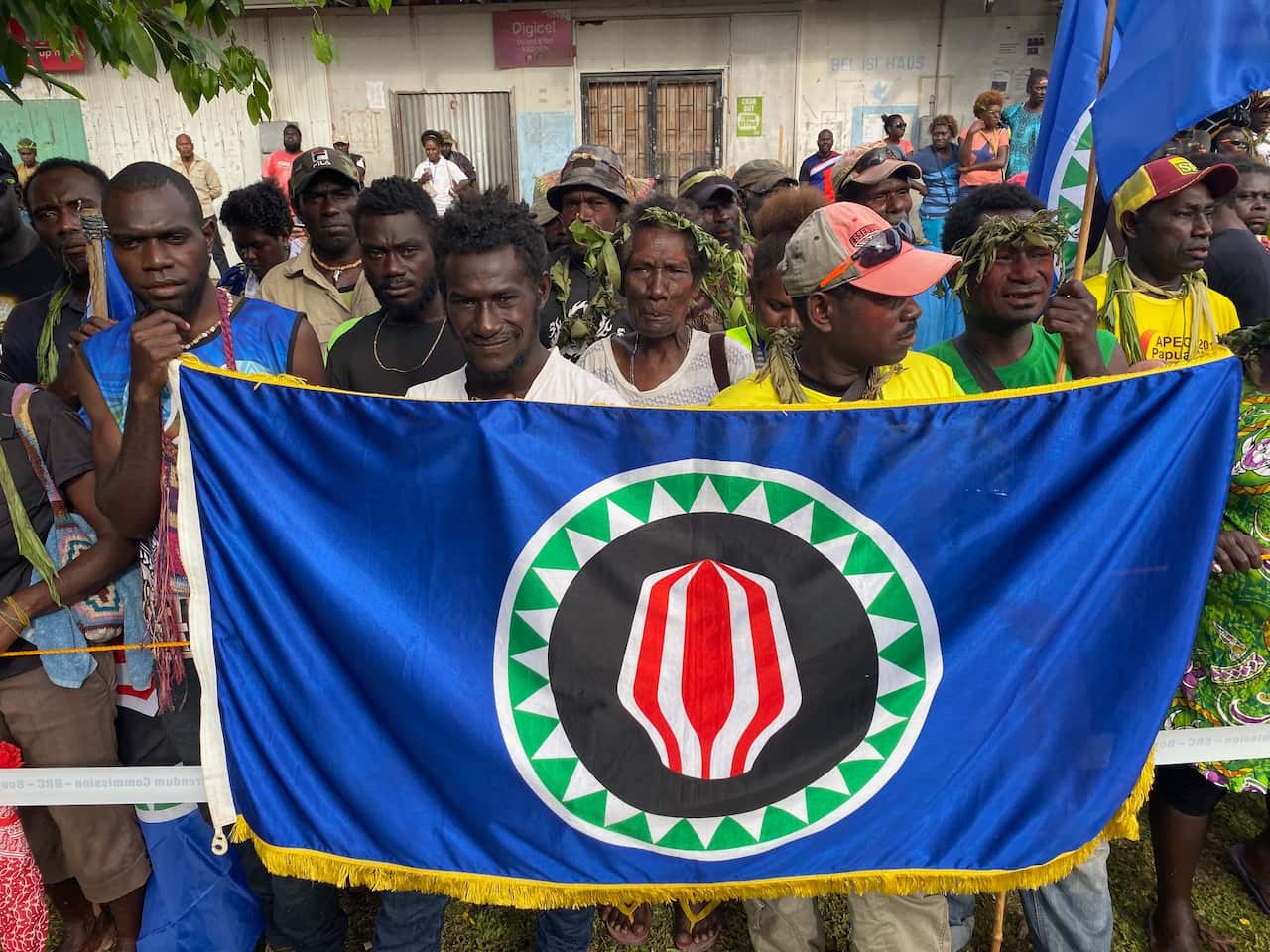 Voters proudly show off the flag of Bougainville, the symbol of the Autonomous Region of Bougainville in Papua New Guinea, as they head to cast their ballots.