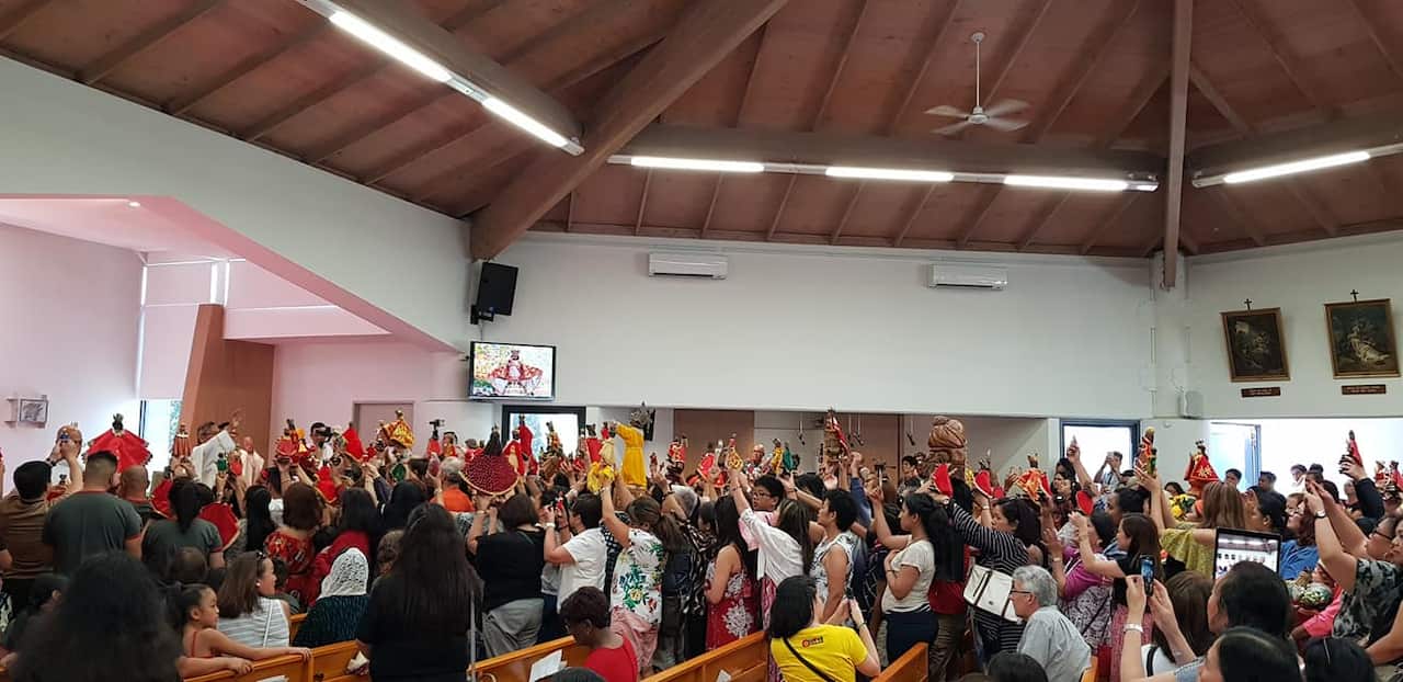 Sinulog patrons bring their Sto. Ninos for blessing at the church