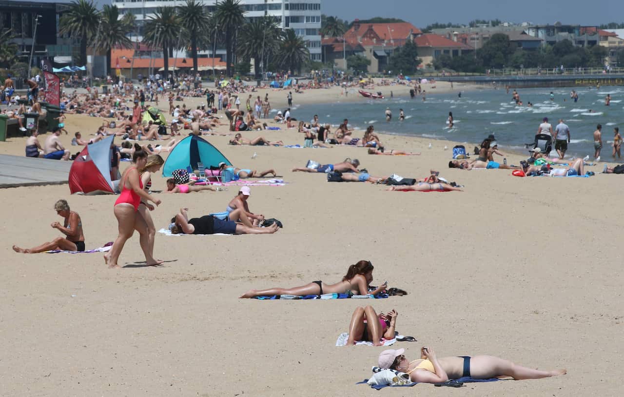 People soak up the sun at St Kilda beach in Melbourne on January 25.