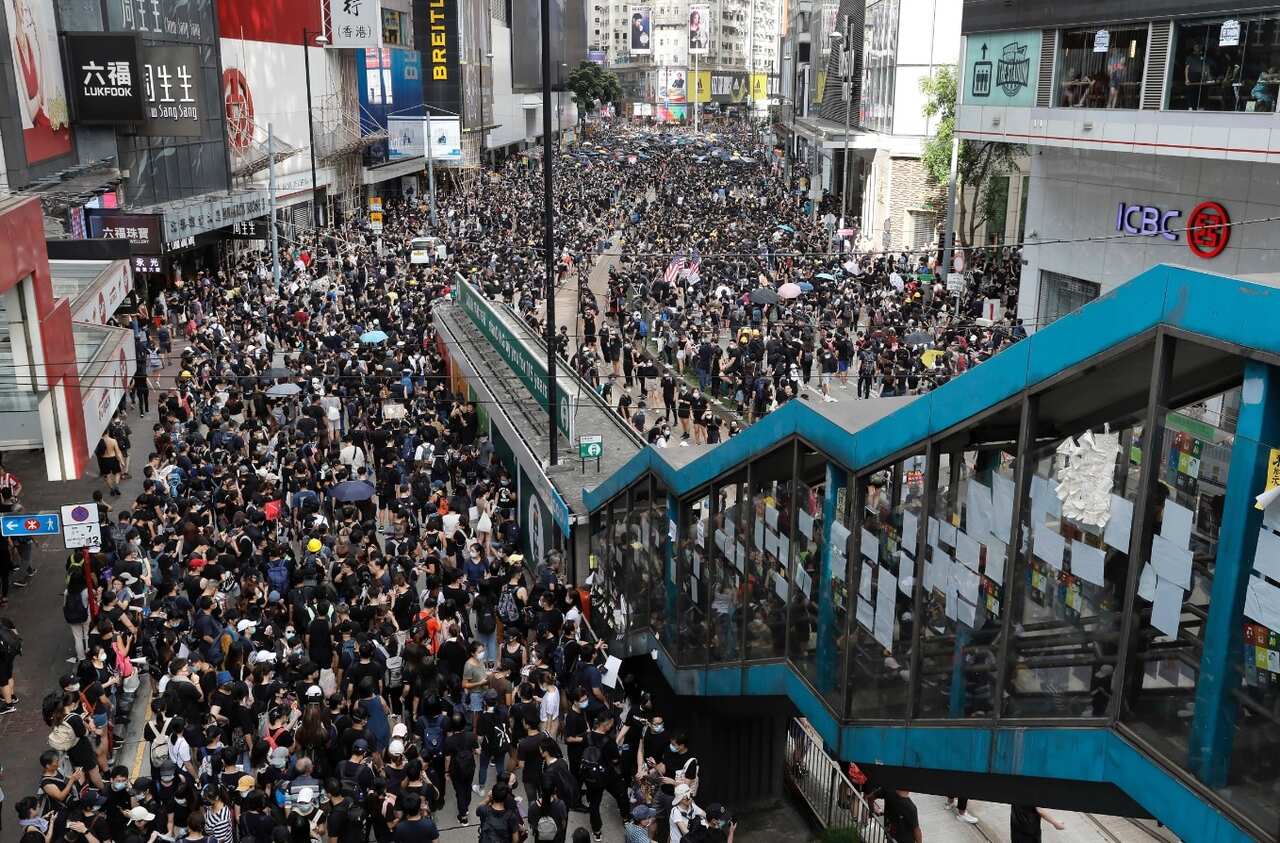 Protesters take part in a march on a street in Hong Kong, Sunday, July 28, 2019.