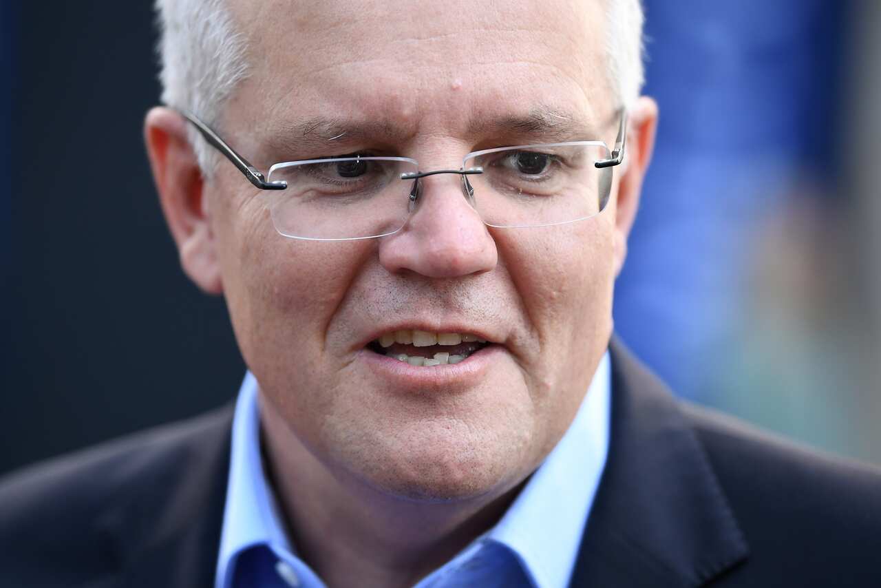 Prime Minister Scott Morrison and wife Jenny speak to the media as they arrive at the Horizon Church in Sutherland.
