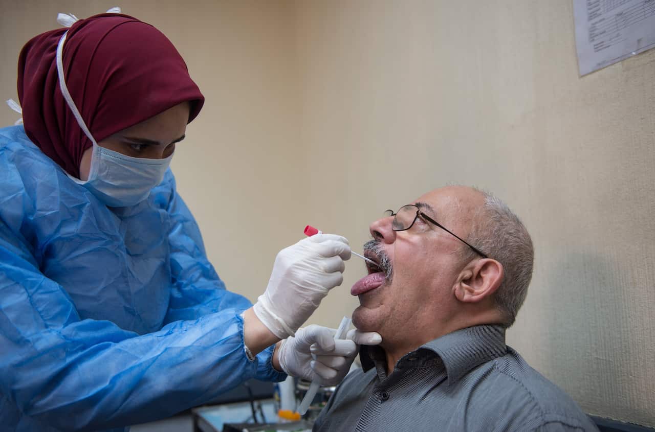 A doctor takes a sample for Covid-19 test in Cairo, Egypt