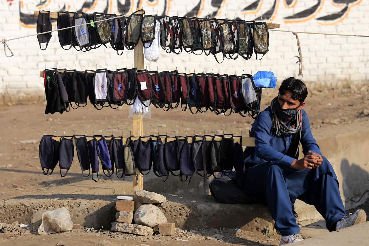 A man sells protective face masks after positive cases of novel coronavirus were confirmed in Afghanistan. 