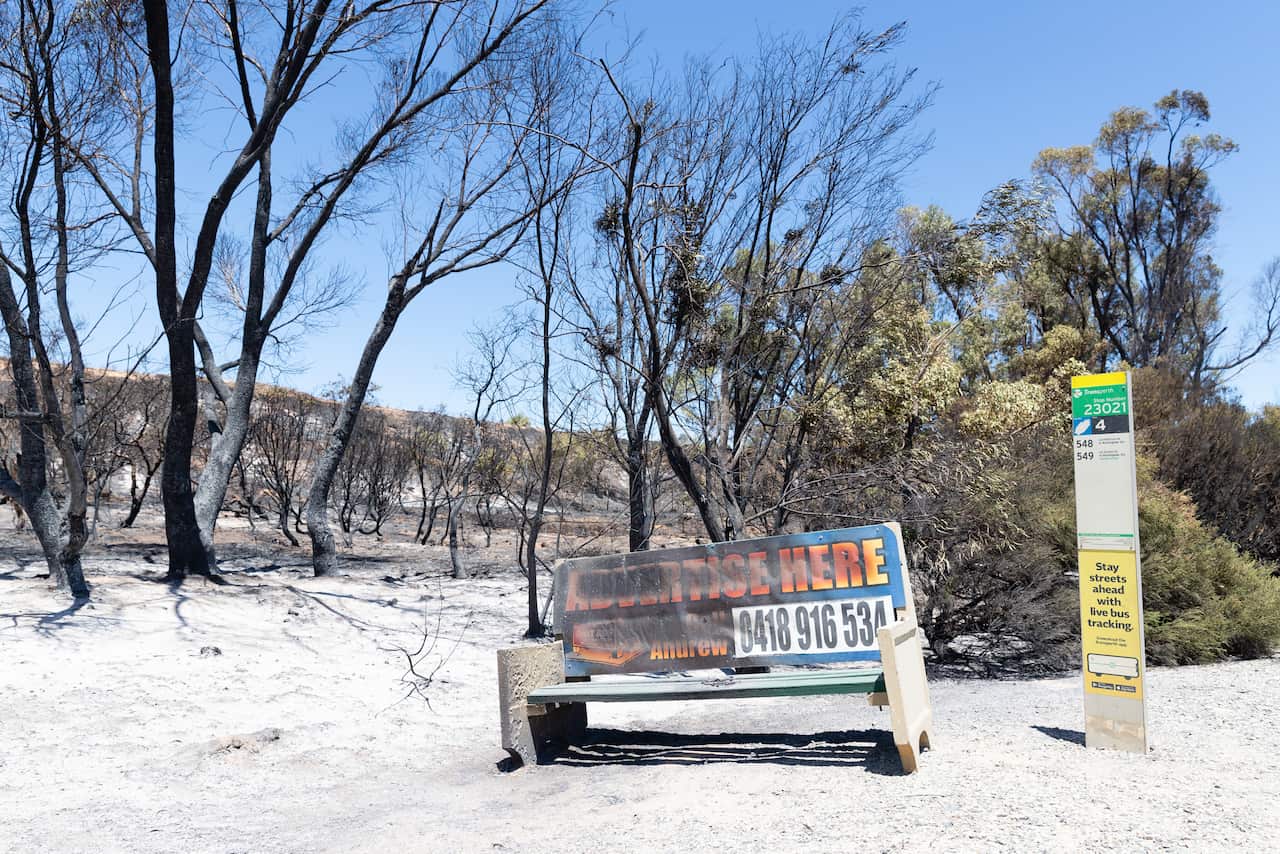 A bushfire damaged bus stop is seen on Patterson Road in Kwinana, south of Perth.