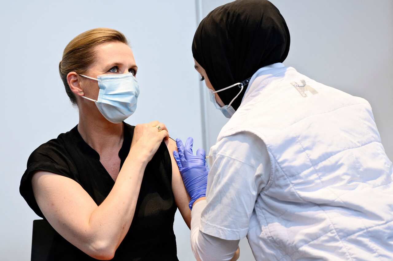 Danish Prime Minister Mette Frederiksen is vaccinated against Covid-19 by Huda Beklar in Oksnehallen in Copenhagen, on 4 June.